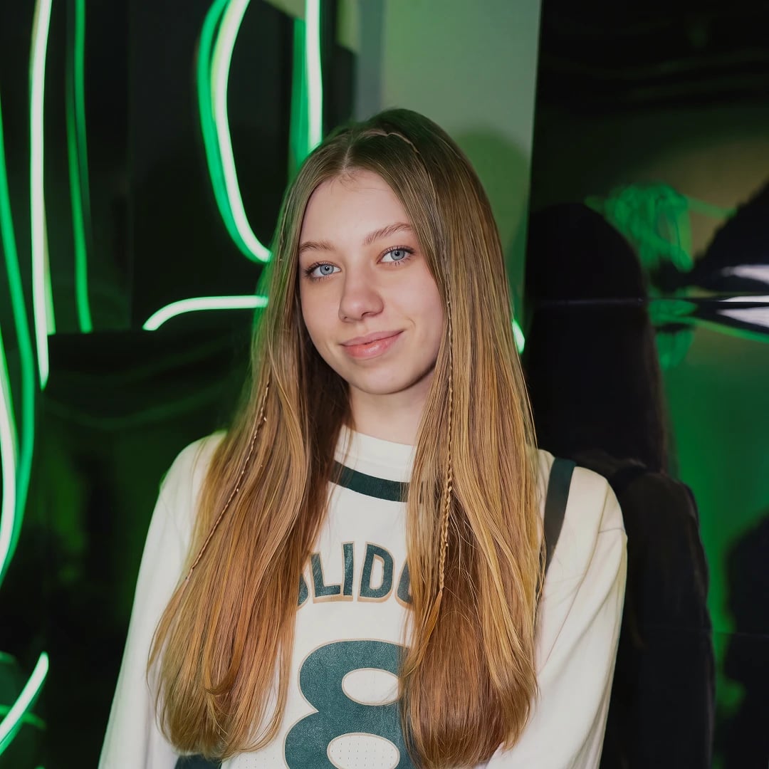 Anastasiia wearing a Solidgate jersey under neon lights