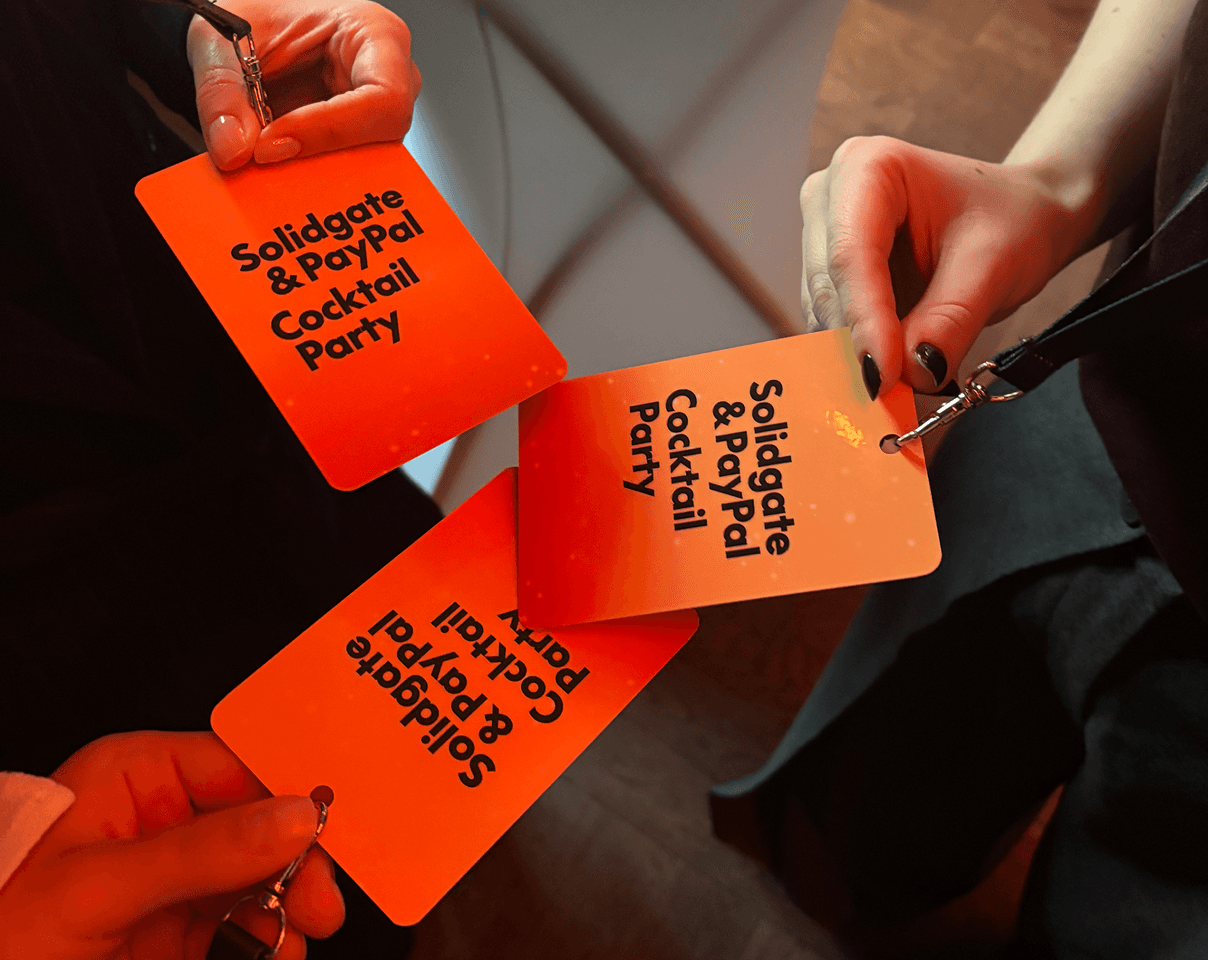 Three orange event passes with 'Solidgate & PayPal Cocktail Party' text.
