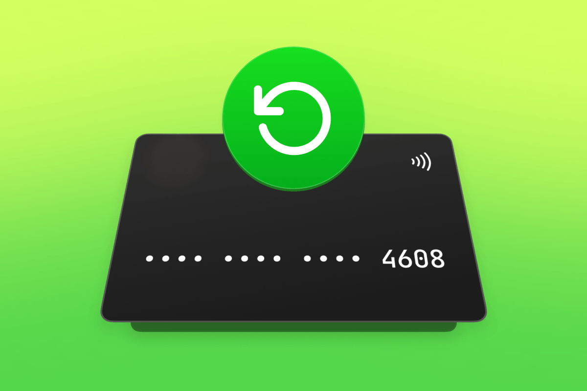 A black credit card with masked numbers and a green refresh icon above it.