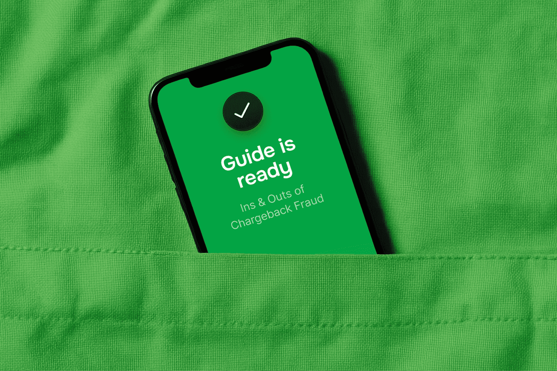 Smartphone in a green pocket displaying a 'Guide is ready: Ins & Outs of Chargeback Fraud' message.