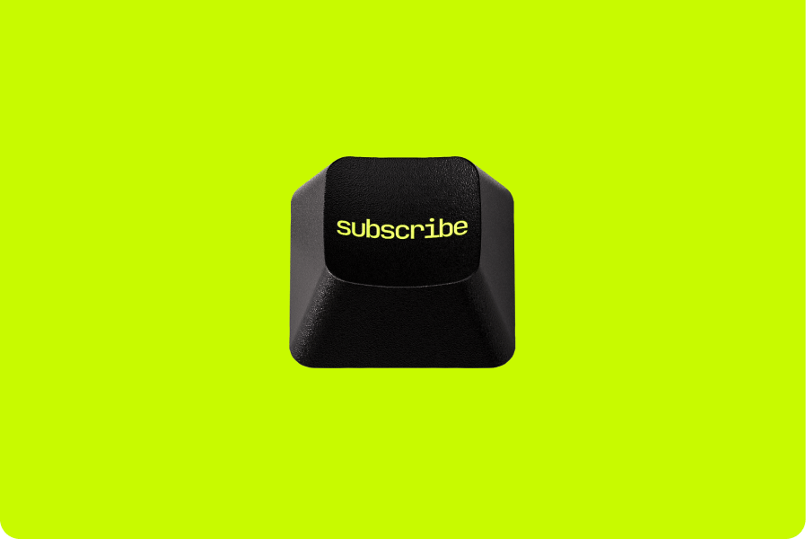 A black keyboard key with the word "subscribe" printed on it set against a bright neon yellow background.